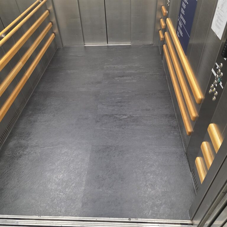 The same elevator floor with a new stone-pattern mat