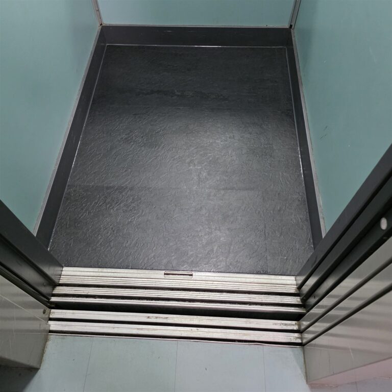 Renewed elevator floor with a seamless dark surface
